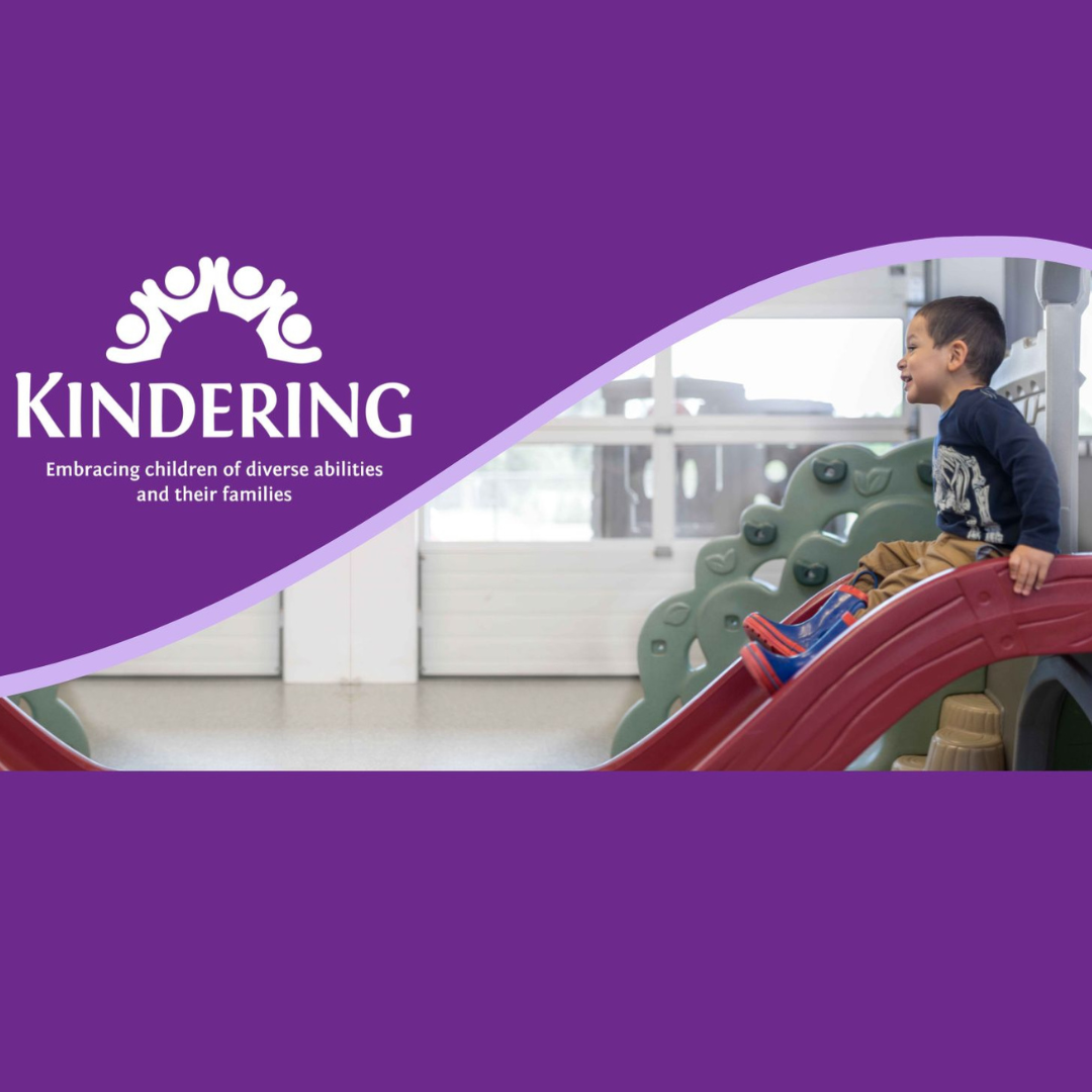 a child on a slide at kindering
