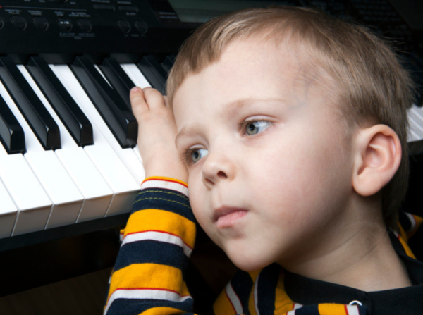 frustrated child with head on piano