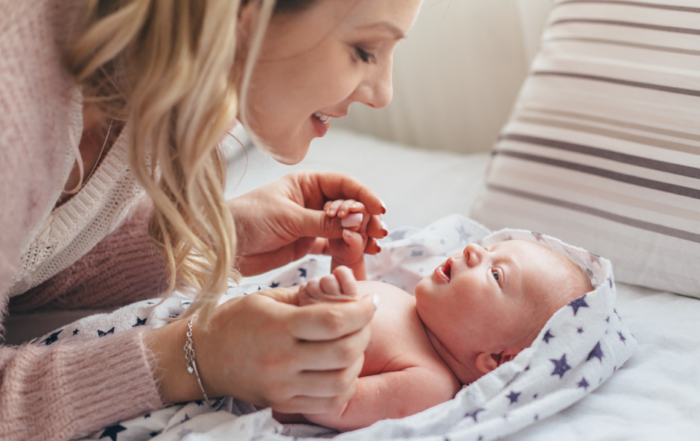 mom singing to newborn baby