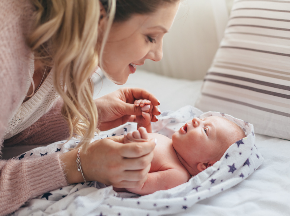 mom singing to newborn baby