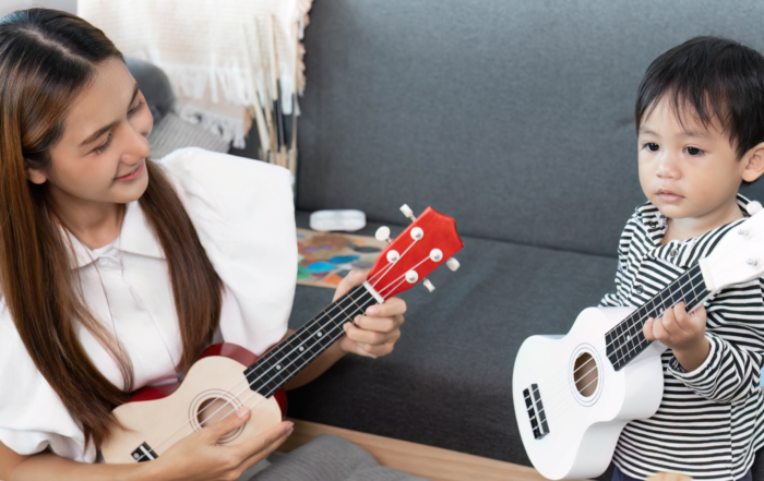 mom and toddler playing guitar together