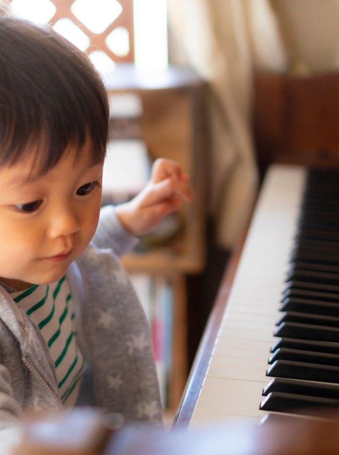 toddler practicing piano