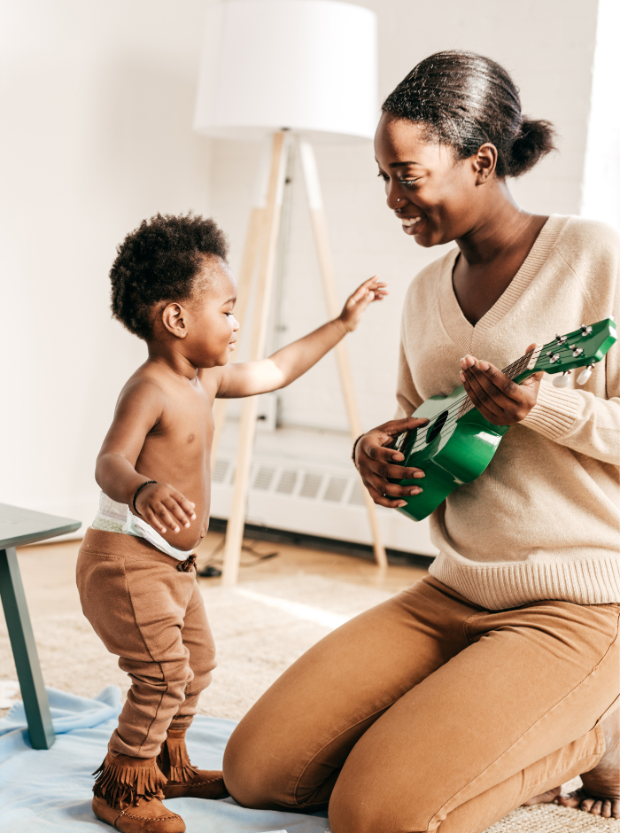 mom and toddler playing piano